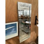 A BEVELED EDGE WALL MIRROR WITH MIRRORED FRAME