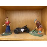 A METAL MOTORBIKE FIGURE AND TWO GOLFING CAST IRON DOOR STOPS