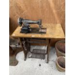 A VINTAGE SINGER SEWING MACHINE WITH CAST TREADLE BASE