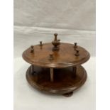 A 19TH CENTURY WALNUT BOBBIN HOLDER ON THREE FEET WITH A TURNED FINIALE TO HOLD SIX BOBBINS