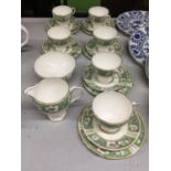 A CHINA TEASET IN A GREEN AND WHITE FLORAL PATTERN TO INCLUDE CUPS, SAUCERS, SIDE PLATES, CREAM
