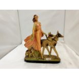 AN EARLY 20TH CENTURY ART DECO STYLE CHALKWARE FIGURE OF A LADY AND TWO GERMAN SHEPHERDS MARKED RD