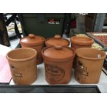 SIX TERRACOTTA STORAGE CANNISTERS