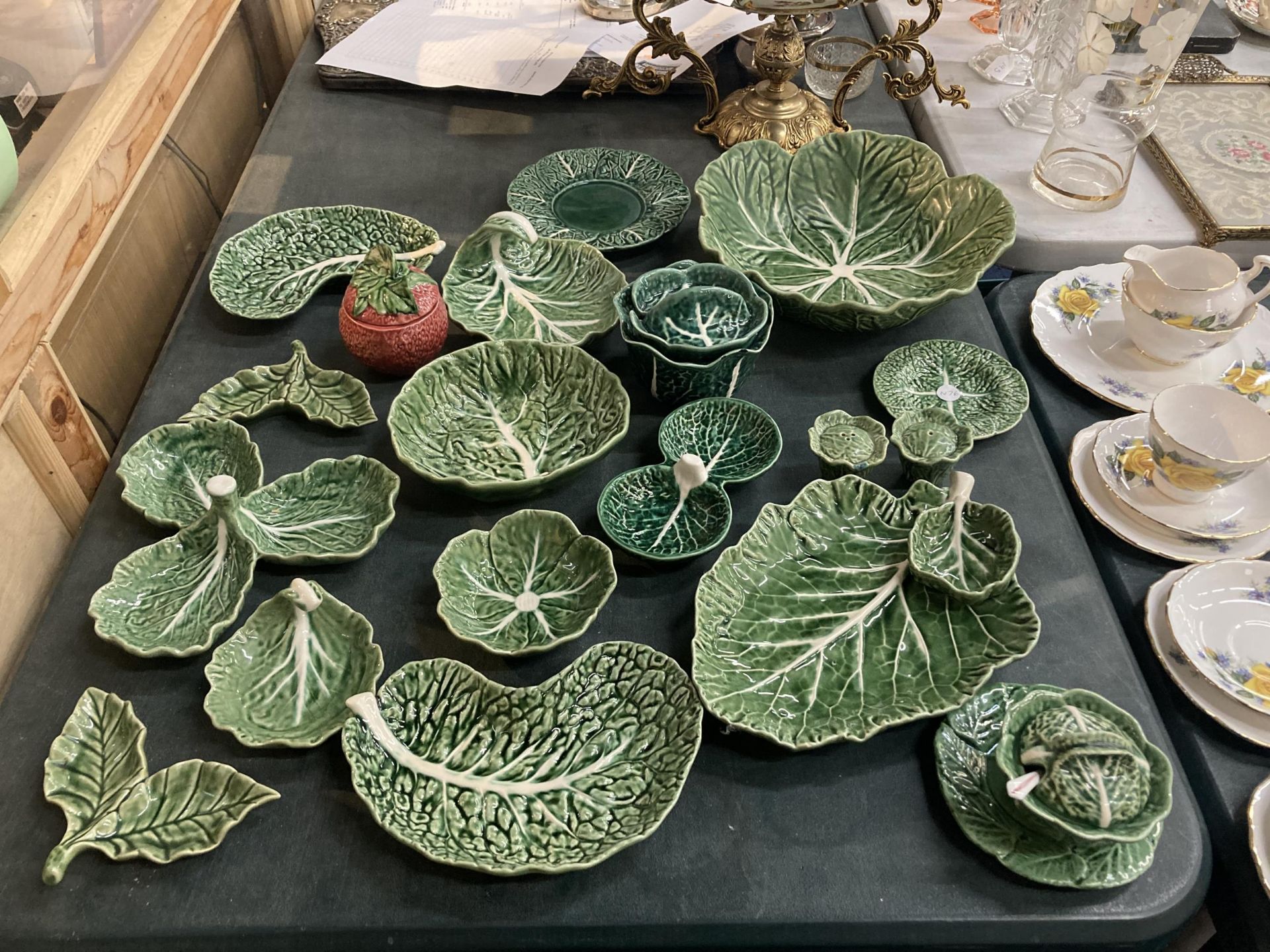 A LARGE QUANTITY OF 'CABBAGE LEAF' POTTERY TO INCLUDE PLATES, BOWLS, CRUETS, ETC