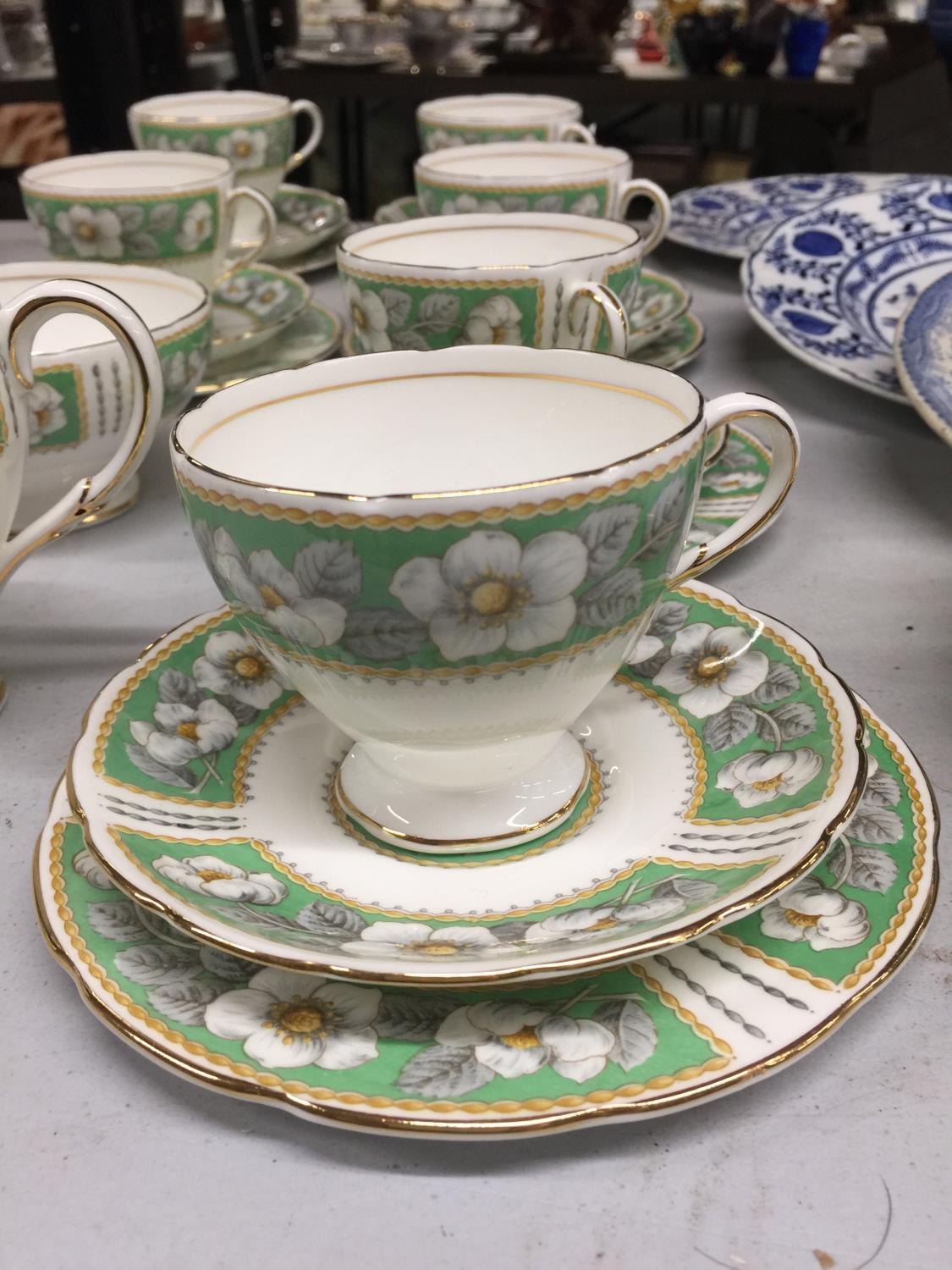 A CHINA TEASET IN A GREEN AND WHITE FLORAL PATTERN TO INCLUDE CUPS, SAUCERS, SIDE PLATES, CREAM - Image 2 of 3