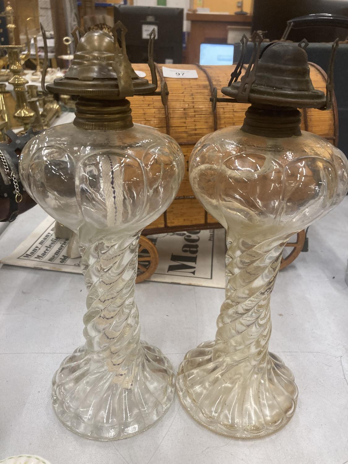 A PAIR OF VINTAGE GLASS OIL LAMPS WITH BARLEY TWIST STEM