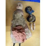 A VICTORIAN DOLL IN PERIOD COSTUME WITH A WAX HEAD, STRAW/HORSEHAIR BODY, PLASTER ARMS AND LOWER