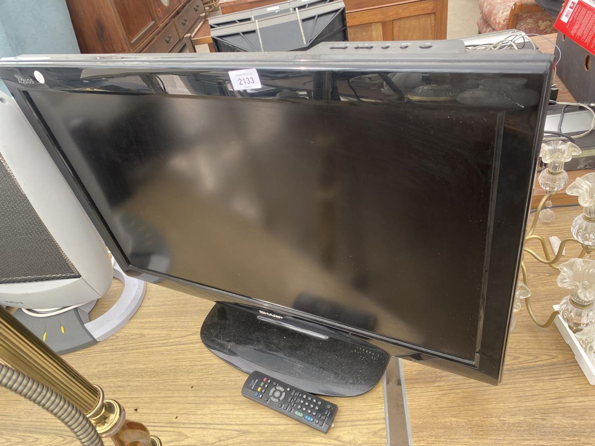 A SHARP 32" TELEVISION WITH REMOTE CONTROL