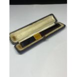 AN AMBER CHEROOT HOLDER IN A CASE