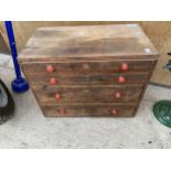 A MINITURE WOODEN ENGINEERS CHEST WITH FOUR DRAWERS