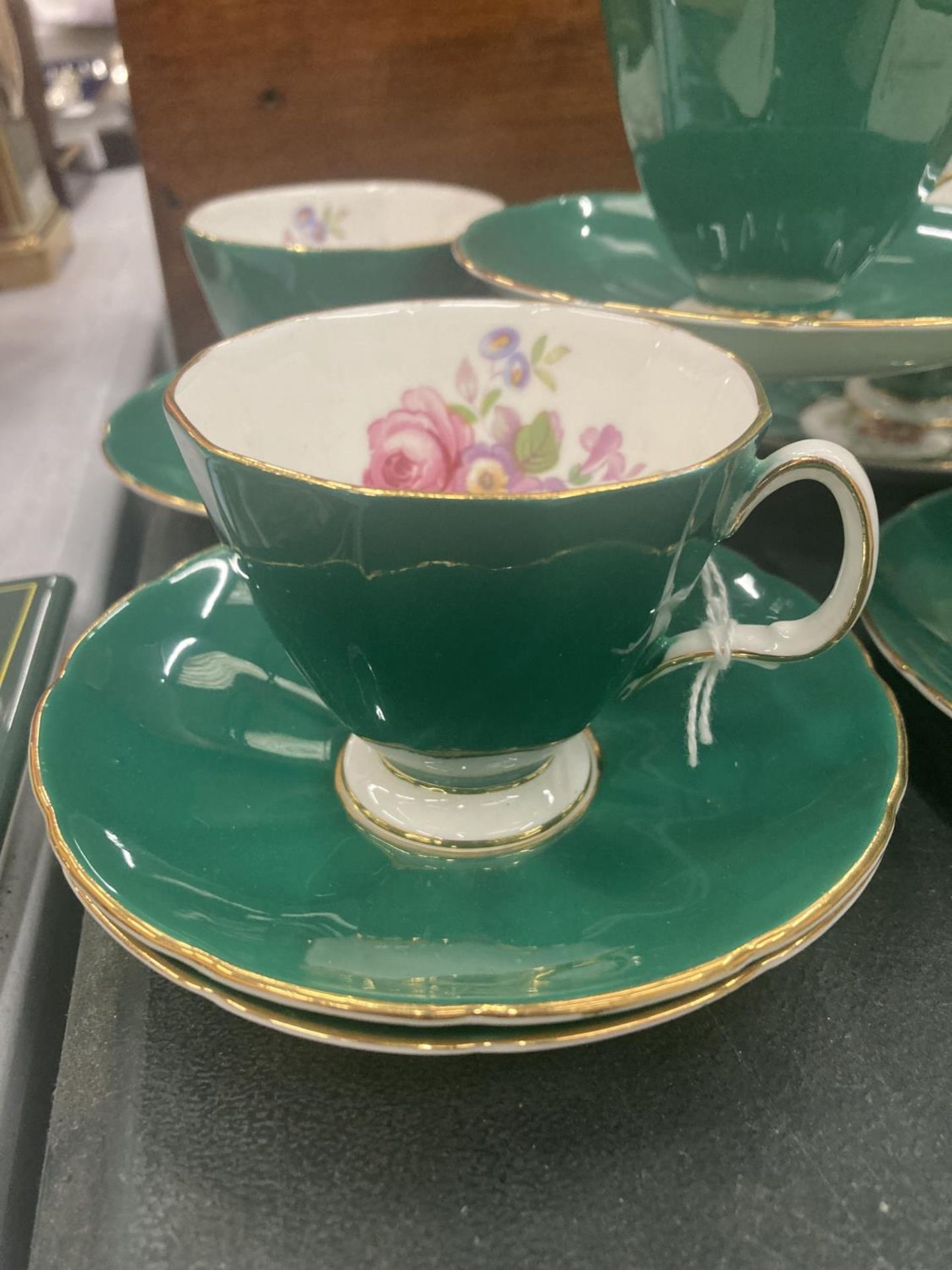 FIVE ADDERLEY CHINA CUPS AND SIX SAUCERS IN A DARK GREEN WITH A FLORAL PATTERN - Image 2 of 4