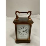 A COPPER CARRIAGE CLOCK WITH BRASS MOVEMENT BY Wm BUFORD AND SON EASTBOURNE AND EXETER WITH TOP