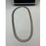 A SILVER NECKLACE IN A PRESENTATION BOX