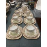 A TUSCAN TEASET WITH A COACHING SCENE DESIGN TO INCLUDE A CAKE PLATE, CREAM JUG, SUGAR BOWL, CUPS,