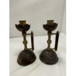A PAIR OF COPPER AND BRASS CANDLESTICKS IN THE STYLE OF CHRISTOPHER DRESSER