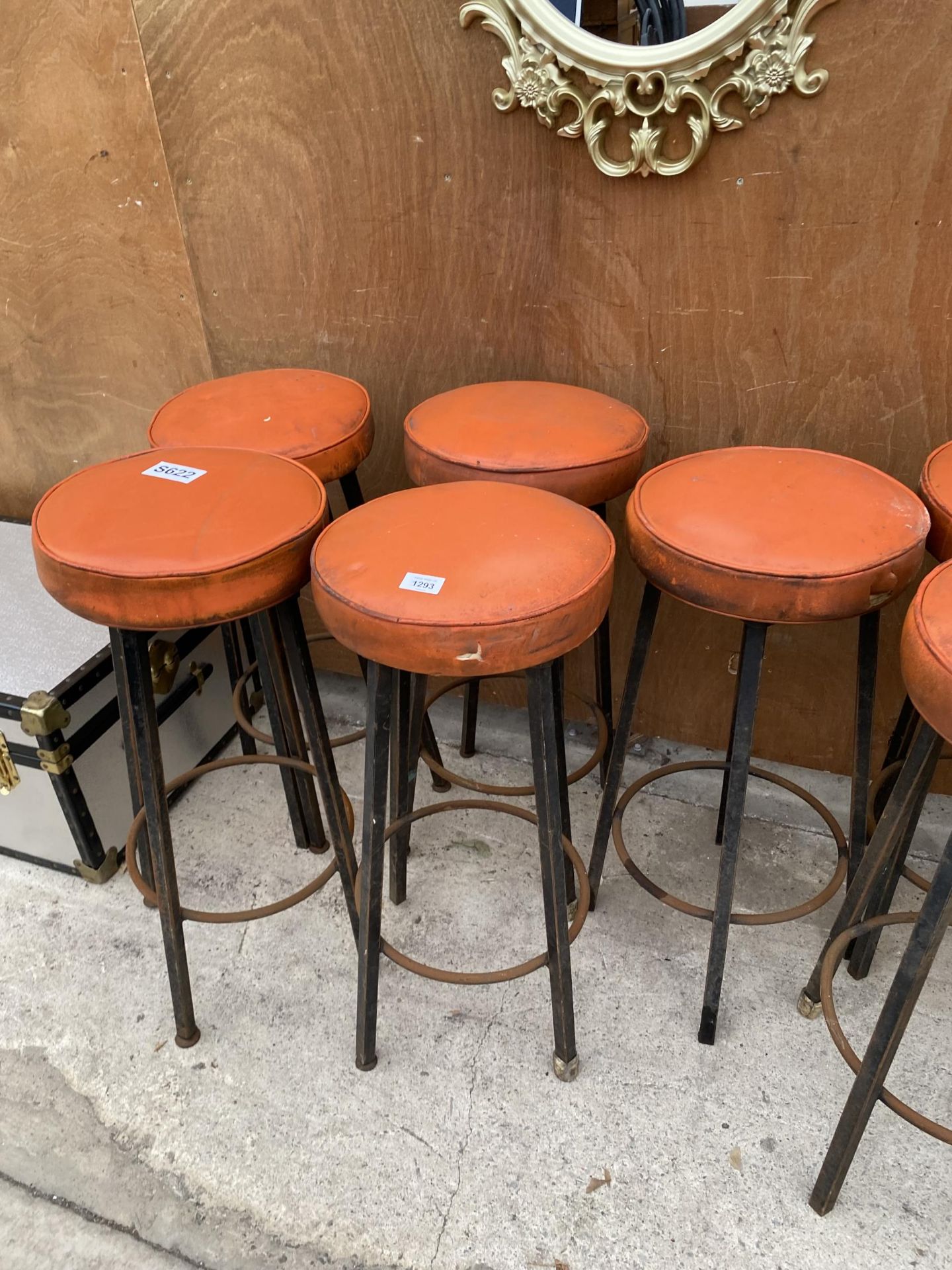 A SET OF FOUR RETRO ORANGE STOOLS WITH METAL LEGS