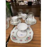 A COLCLOUGH TEASET IN A PALE GREEN FLORAL PATTERN TO INCLUDE A CAKE PLATE, CREAM JUG, SUGAR BOWL