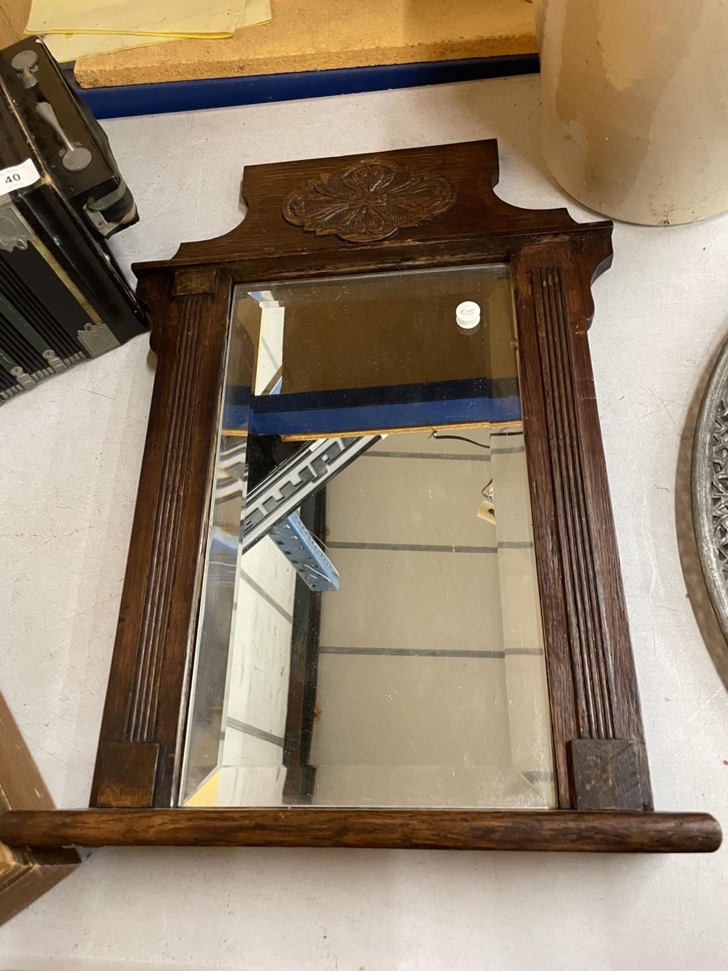 A VICTORIAN OAK FRAMED BEVELLED WALL MIRROR WITH SHELF