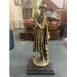 A FIGURINE OF A LADY HOLDING A DOG ON A PLINTH HEIGHT APPROX 33CM