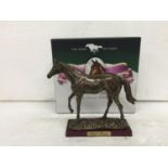 A BOXED RESIN SCULPTURE OF RED RUM RACE HORSE ON WOODEN PLINTH