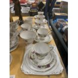 A ROYAL STAFFORD CHINA TEASET WITH ROSE AND GILT PATTERN TO INCLUDE A CAKE PLATE, CUPS, SAUCERS,