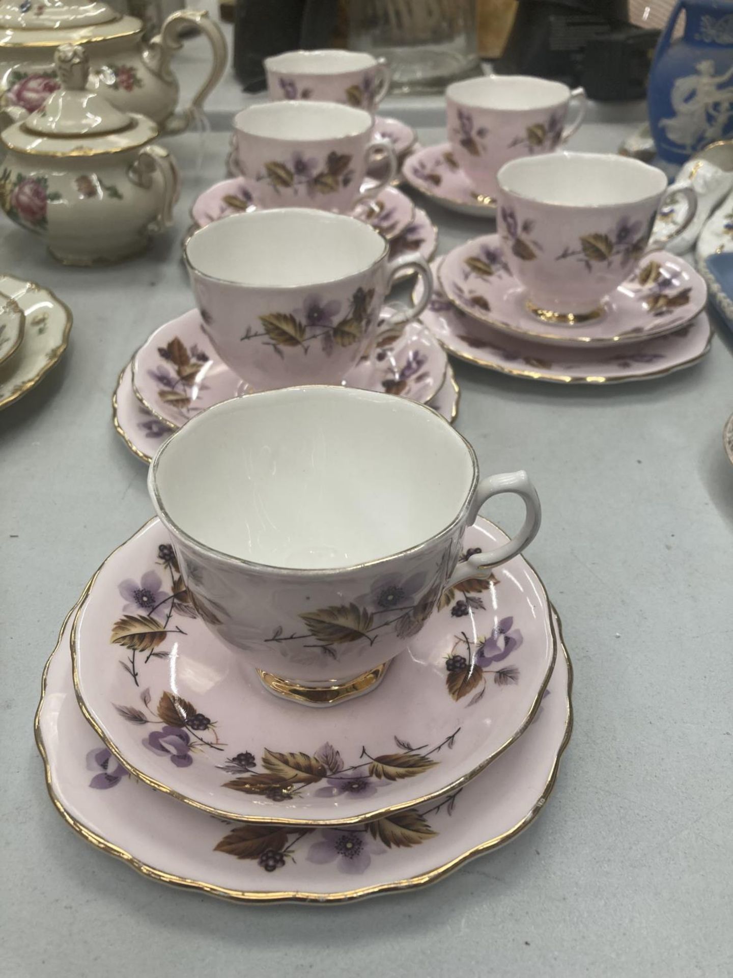 FIVE COLCLOUGH TRIOS IN LILAC WITH BLACKBERRY PATTERN PLUS A CUP AND SAUCER
