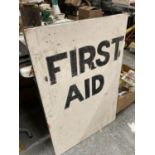 A VINTAGE 'FIRST AID' SIGN ON AN A-BOARD 91.5CM X 61CM