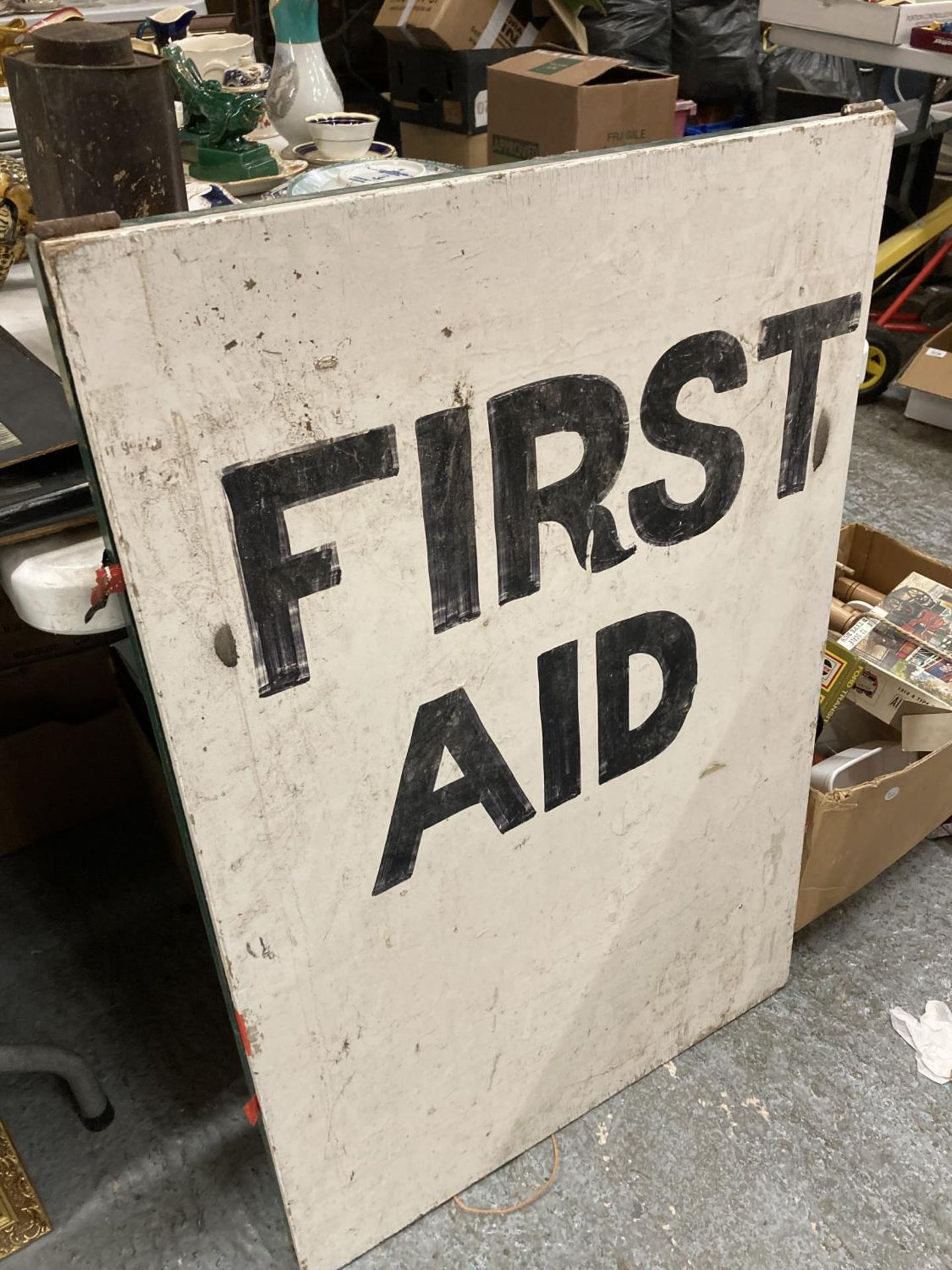 A VINTAGE 'FIRST AID' SIGN ON AN A-BOARD 91.5CM X 61CM