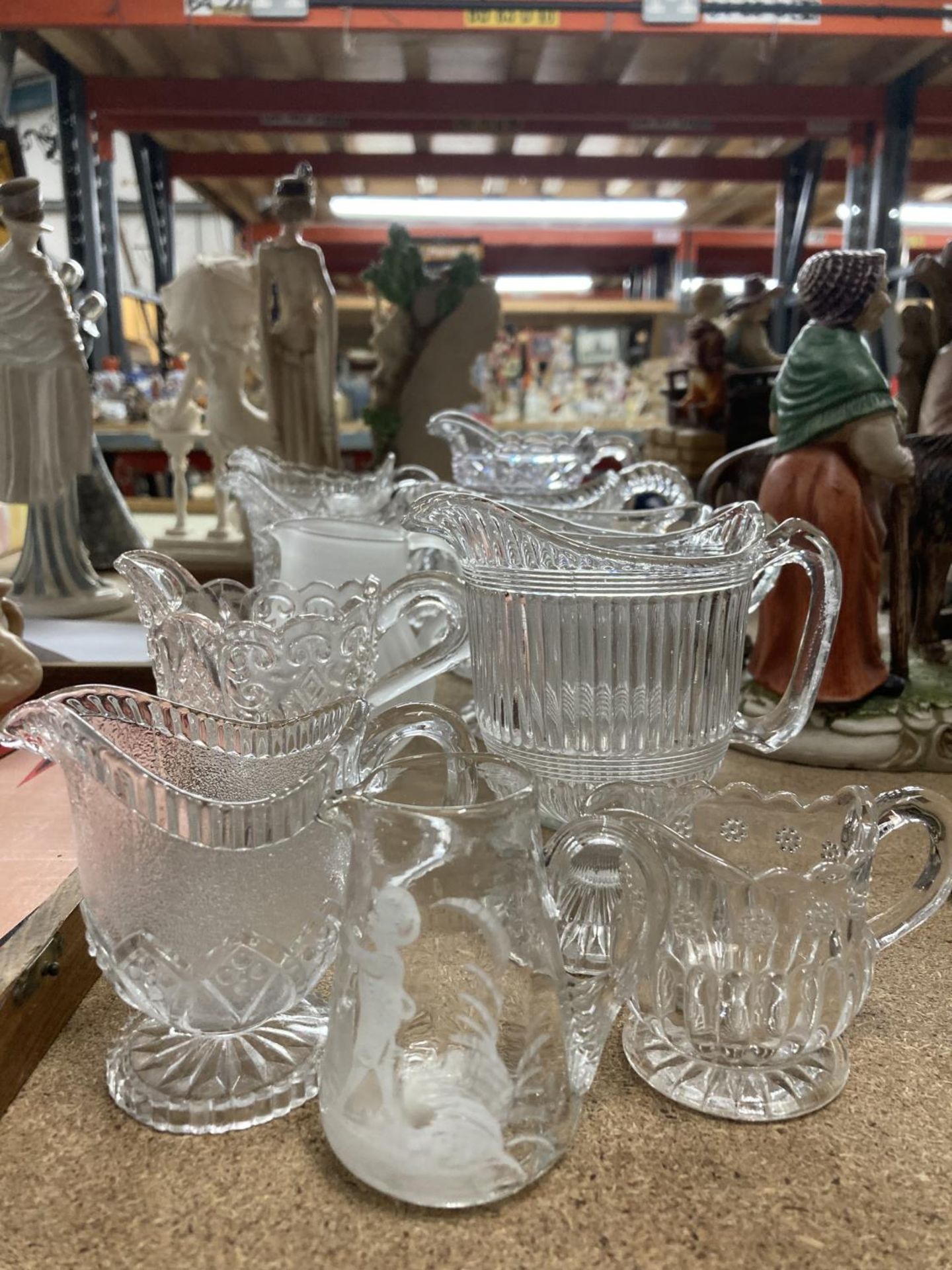 A QUANTITY OF GLASS JUGS TO INCLUDE A MARY GREGORY