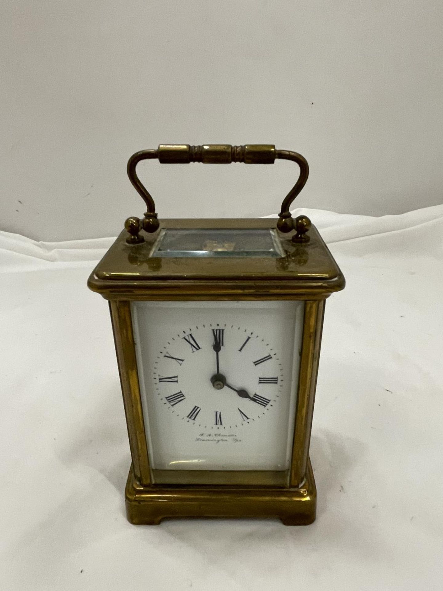 A BRASS CARRIAGE CLOCK BY F A CHANDLER LEMINGTON SPA WITH TOP ESCAPEMENT VEIWING PANE