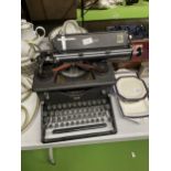 A VINTAGE IMPERIAL TYPEWRITER WITH DUST COVER
