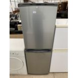 A SILVER HOTPOINT UPRIGHT FRIDGE FREEZER