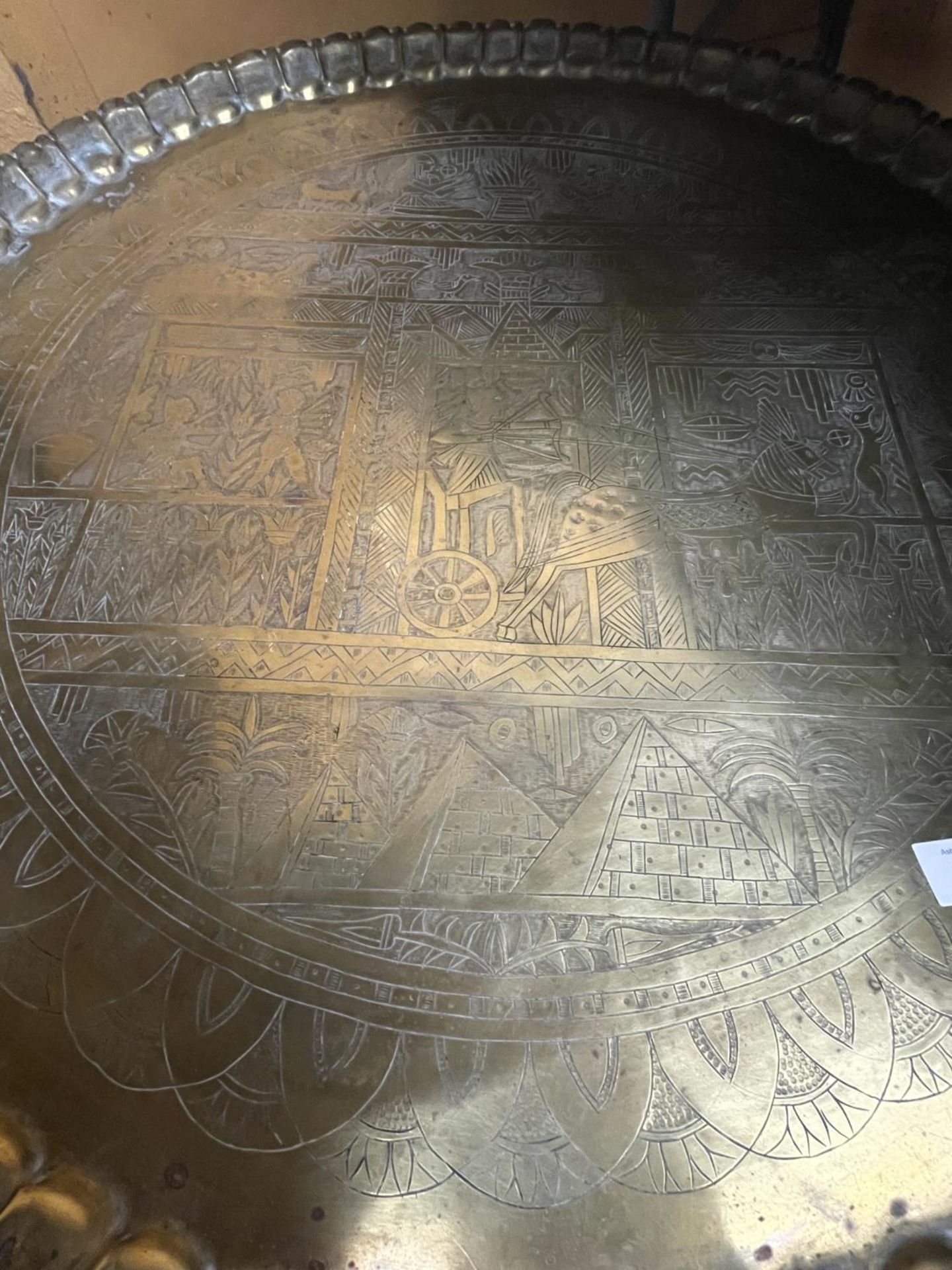 A LARGE SIX LEGGED FOLDING TABLE WITH BRASS TOP DEPICTING EGYPTIAN LIFE DIAMETER 73CM - Image 3 of 4