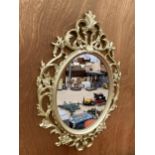 A DECORATIVE FRAMED WALL MIRROR