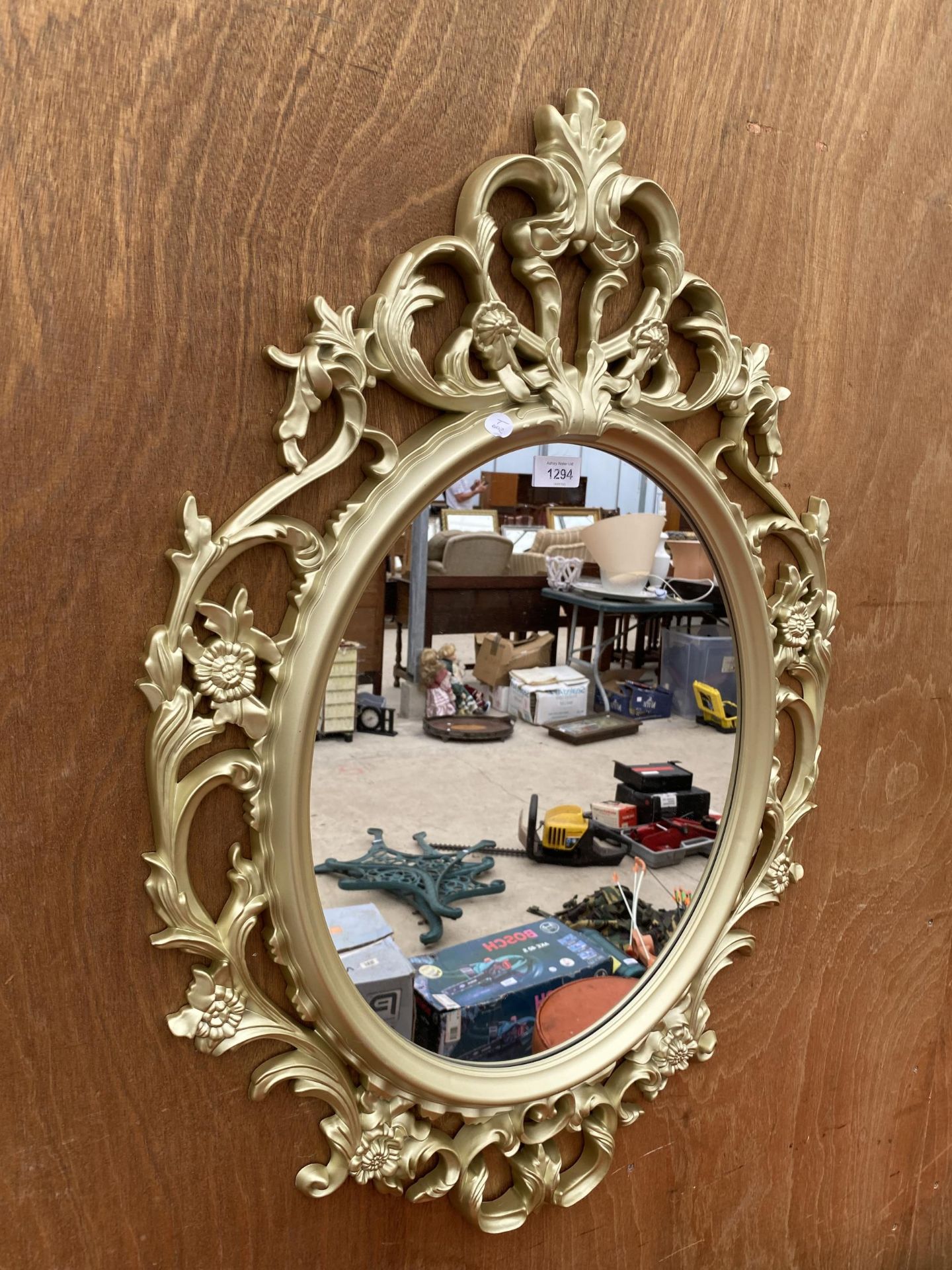 A DECORATIVE FRAMED WALL MIRROR