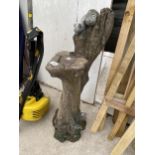 A RECONSTITUTED STONE GARDEN FIGURE OF A TREE STUMP WITH WILDLIFE