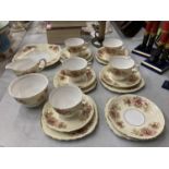 A COLCLOUGH CHINA TEASET IN A PALE YELLOW WITH FLORAL DECORATION TO INCLUDE A CAKE PLATE, CREAM JUG,
