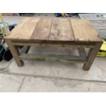 A WOODEN PLANK TOP OUTDOOR COFFEE TABLE