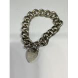 A HEAVY CURB LINK MARKED SILVER BRACELET WITH HEART LOCKET CLASP