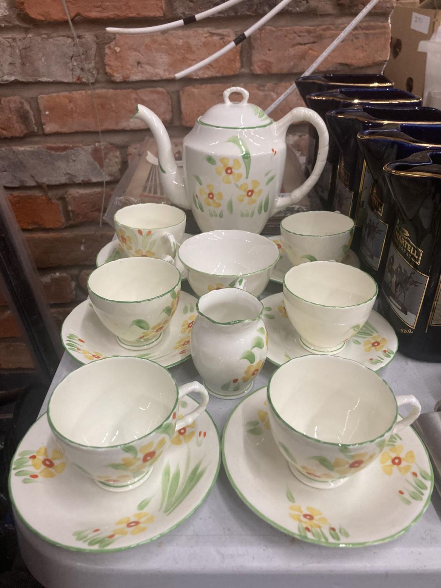A SUTHERLAND COFFEE SET IN A DELICATE YELLOW WITH FLORAL DECORATION TO INCLUDE A COFFEE POT, CREAM