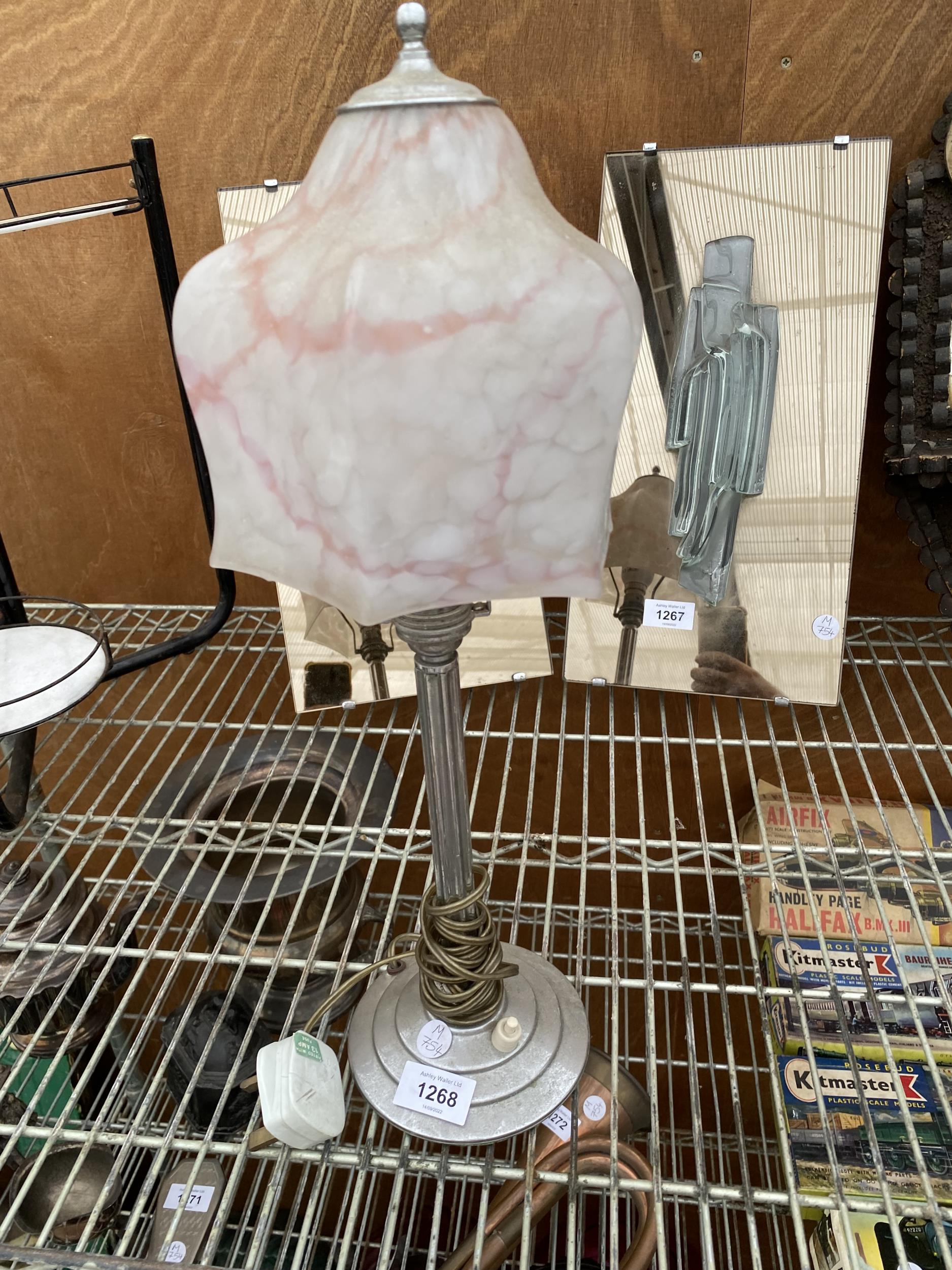 A DECORATIVE METAL TABLE LAMP WITH GLASS SHADE