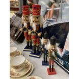 TWO LARGE AND TWO SMALLER WOODEN NUTCRACKER CHRISTMAS FIGURES