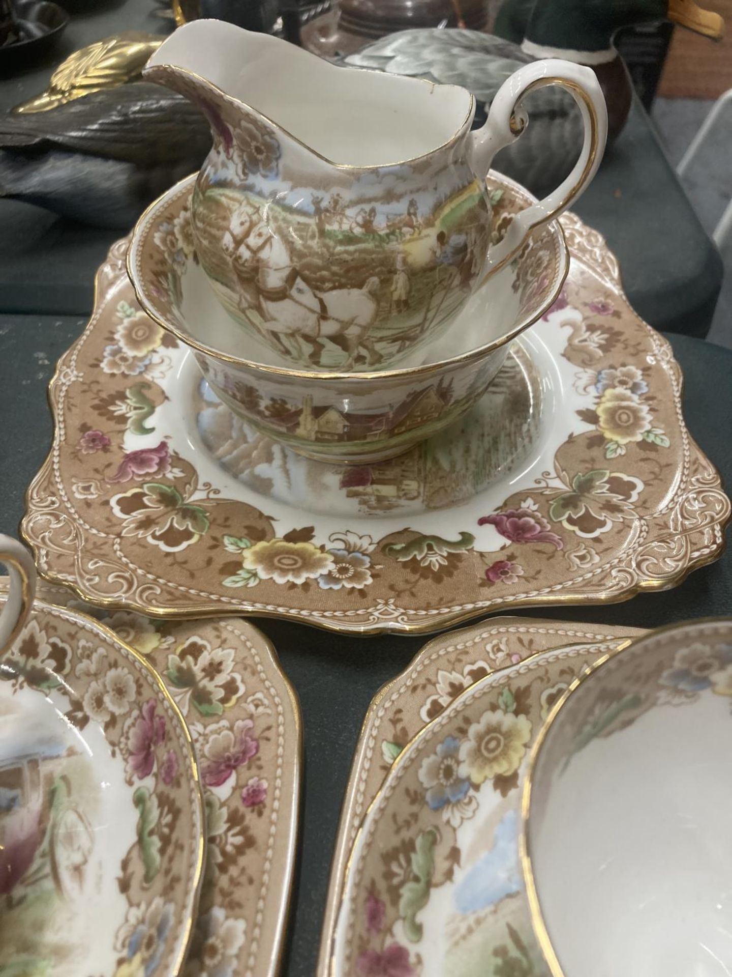 A TUSCAN TEASET WITH A COACHING SCENE DESIGN TO INCLUDE A CAKE PLATE, CREAM JUG, SUGAR BOWL, CUPS, - Image 4 of 5