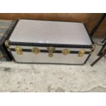 A LARGE METAL BOUND TRAVEL TRUNK WITH BRASS EFFECT HINGES AND FASTENS