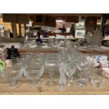 A LARGE QUANTITY OF GLASSWARE TO INCLUDE WINE GLASSES, SHERRY, SMALL TUMBLERS, DESSERT DISHES,