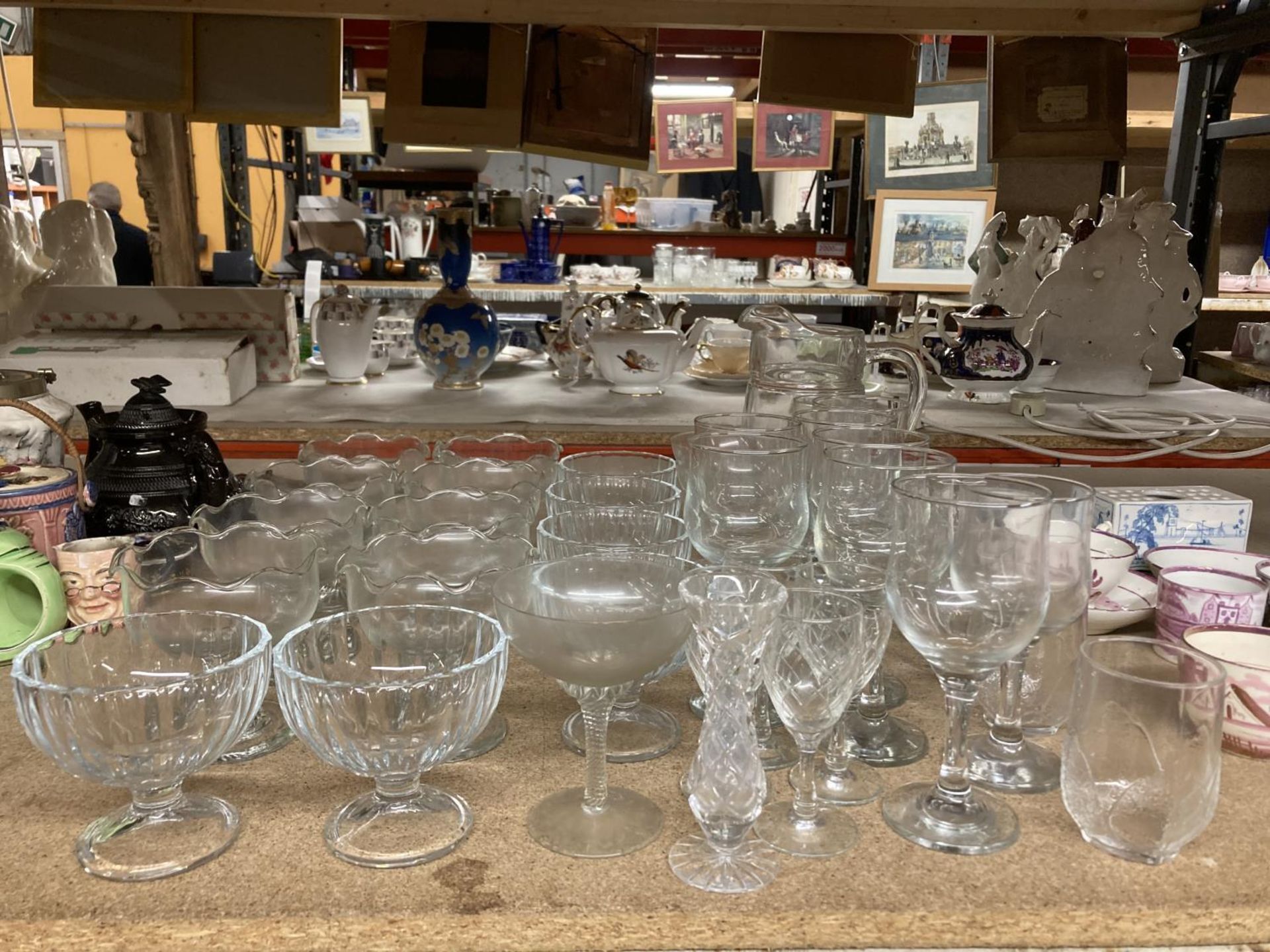 A LARGE QUANTITY OF GLASSWARE TO INCLUDE WINE GLASSES, SHERRY, SMALL TUMBLERS, DESSERT DISHES,