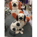 A LARGE RED AND WHITE STAFFORDSHIRE DOG HEIGHT 34CM PLUS A SMALLER BLACK AND WHITE ONE HEIGHT 23CM