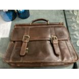 A BROWN WILSON'S LEATHER BRIEF CASE WITH HANDLE