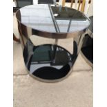 A RETRO 19" DIA POLISHED CHROME LAMP TABLE WITH SMOKED GLASS TOP AND LOWER SHELF