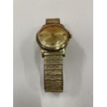 A ACCURIST 9 CARAT GOLD GENTS WRISTWRIST WITH A GOLD PLATED STRAP